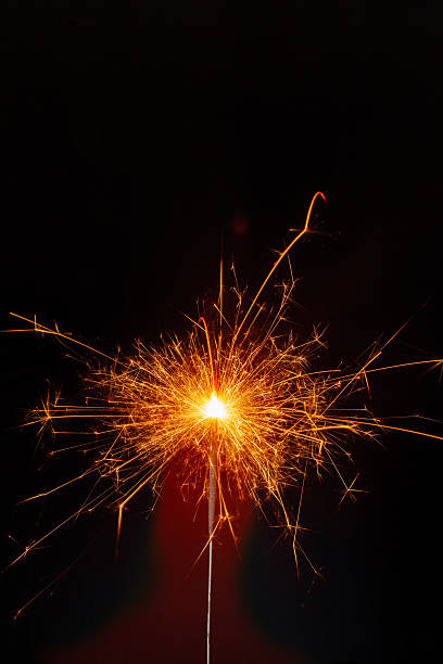 istock Sparkler shining bright during a night celebration with vibrant sparks flying around 2250915738