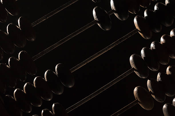 Old abacus lay on stone table, close up black and white photo with selective focus