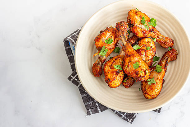 istock Juicy Oven-Roasted Chicken Legs with Spices and Fresh Herbs 2250916941