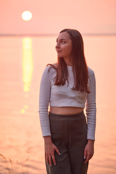 Beautiful young woman posing at Kalemegdan, Belgrade, with a focus on her in the foreground and the historic surroundings softly blurred.