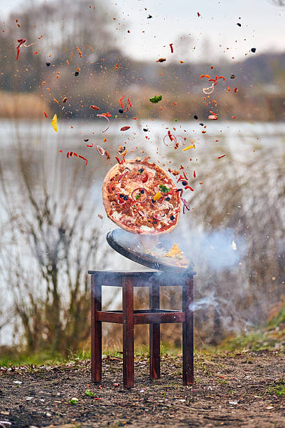 istock Chaotic pizza explosion by scenic lake 2250917353