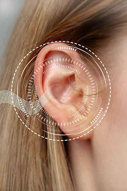 istock Close-up view of a human ear with sound wave graphics indicating auditory activity and analysis in a modern setting 2250917766