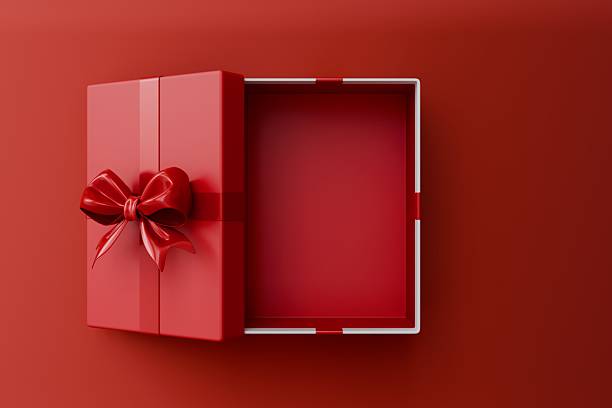 istock Blank red rectangle gift box mock up open or top view of white present box product display showcase frame tied with red ribbon bow resting on a vibrant red background. 2250918502
