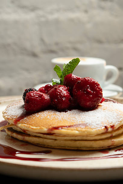Pancakes with berries at the bistro table