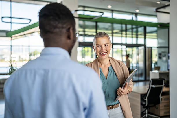 istock Business colleagues meeting, smiling in modern office 2250920505