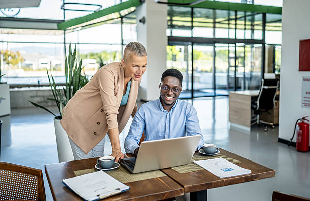 istock Business team collaborating on laptop in modern office 2250921173