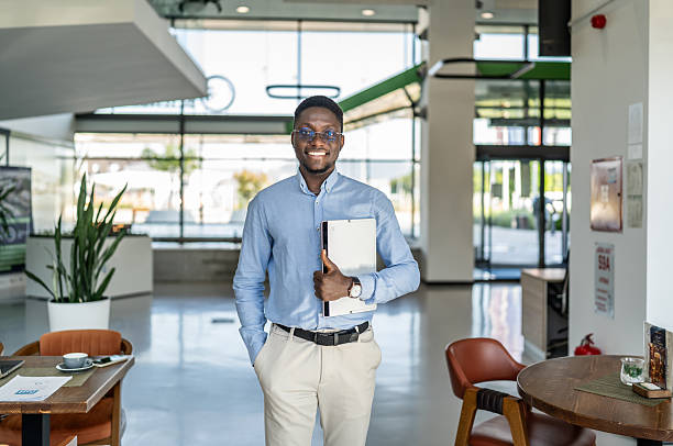 istock Confident African businessman holding digital tablet in modern office 2250921877