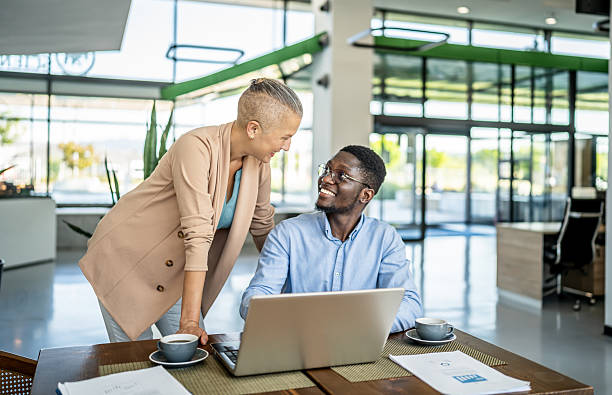 istock Diverse business colleagues collaborating on laptop in office 2250922012