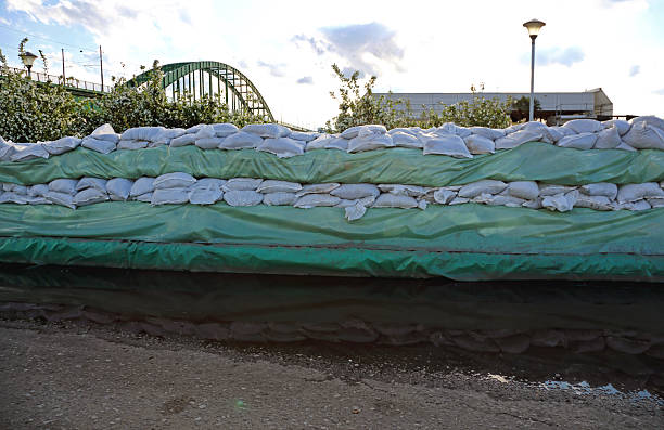 Sandbags are stacked at the entrances to garages to protect against flooding