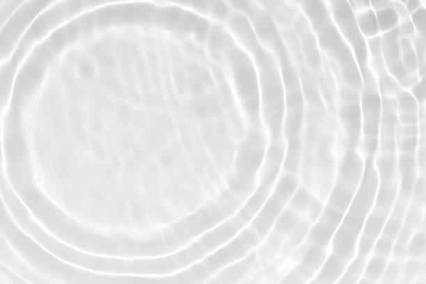 istock White water with ripples on the surface. Defocus blurred transparent white colored clear calm water surface texture with splashes and bubbles. Water waves with shining pattern texture background. 2250928333