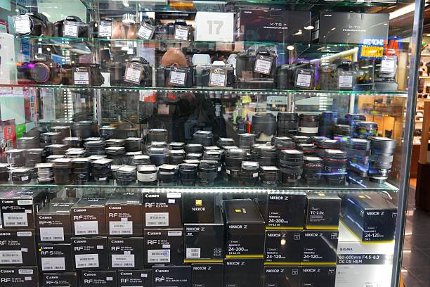 Lenses in a window of photo equipment shop in Sim City mall specializing in photography equipment in Kowloon, Hong Kong.