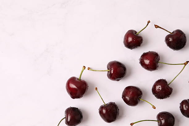 istock Fresh cherries scattered on white. Cherries on a white background. Cherry fruit. Creative fresh cherry pattern background with copy space. Top view. Sprinkled cherry on white background. 2250931491