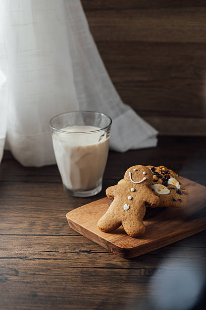 Gingerbread Man Cookie with Milk on Wooden Table in Cozy Setting