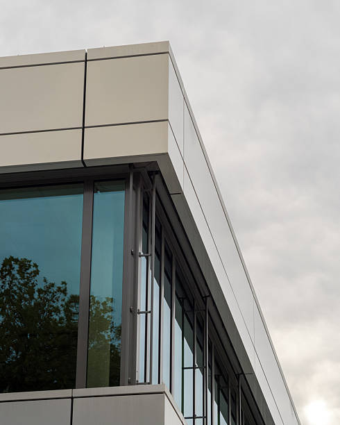 istock Modern office building exterior corner with glass windows reflecting trees 2250934487