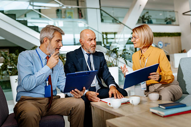 istock Three mature colleagues discussing work during coffee break at the office 2250935577