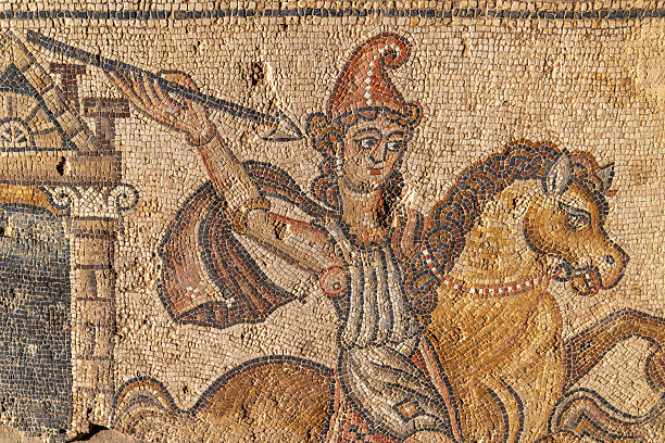 Detailed ancient Roman mosaic featuring a decorative fruit basket, intricate floral patterns, and vibrant tesserae on a floor of ruined ancient church in Hurvat Beit Loya, Israel