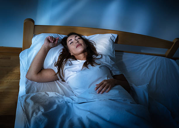 istock Woman sleeps in a bedroom during nighttime hours 2250938101