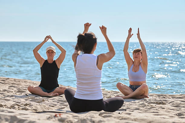 istock Group yoga session by Baltic Sea shore in morning light 2250942482