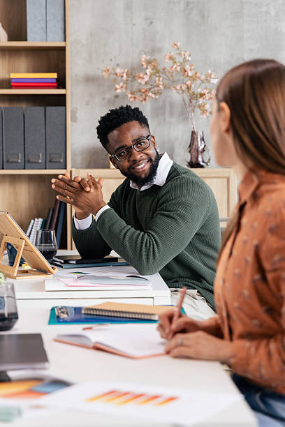 istock Coworkers collaborating and discussing during office meeting 2250942914