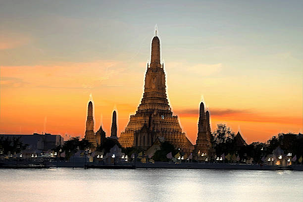 istock Wat Arun glows in golden light at sunset, reflecting over the Chao Phraya River under a dramatic evening sky in Bangkok, Thailand. 2250946884