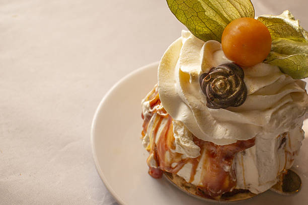 Closeup of physalis, Vivid orange berry on delicate whipped topping