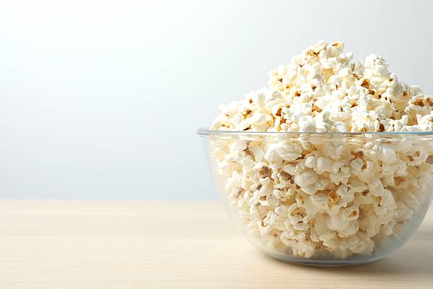 istock Popcorn in a bowl on wooden table 2250947729