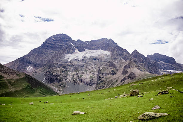 istock A panoramic Himalayan green valley with rolling hills, drifting clouds, and trekkers on a scenic trail. Perfect for themes of adventure, nature, travel, hiking, and outdoor exploration. 2250949887