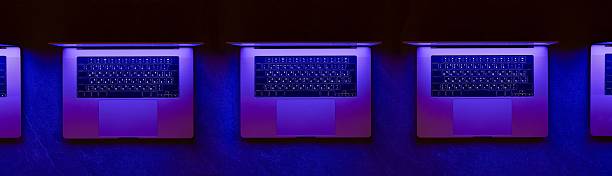 Close-up photo of a modern laptop keyboard captured in dramatic natural light and shadow. The image highlights clean lines and minimalist design, creating an abstract tech composition ideal for themes like remote work, digital tools, modern business environments, cybersecurity, and creative tech backdrops.