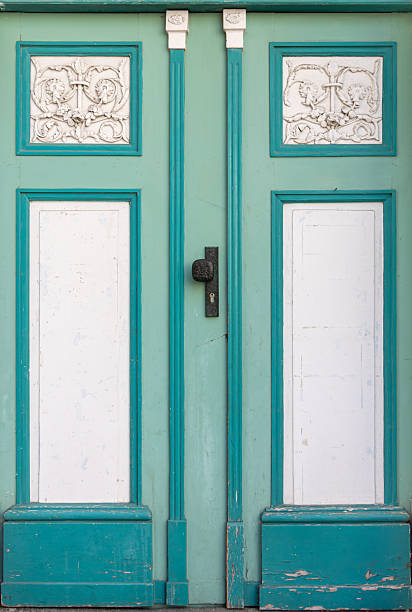 istock Mint doors with white stucco on historic facade. Turquoise decorative doors. 2250950218