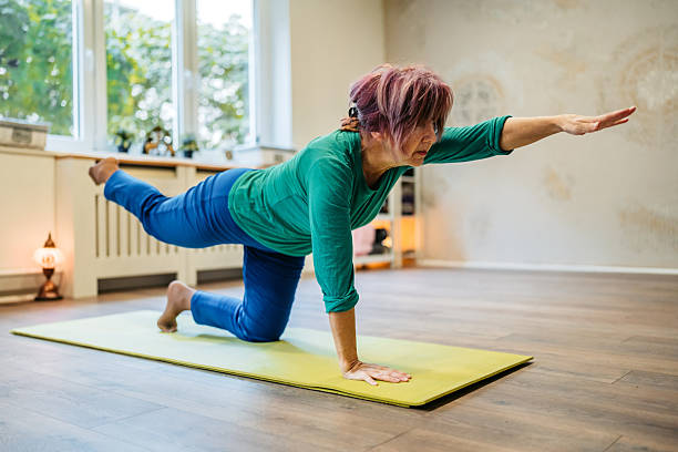 istock Senior Woman Doing The Balancing Table Pose In A Yoga Studio Indoors 2250950615