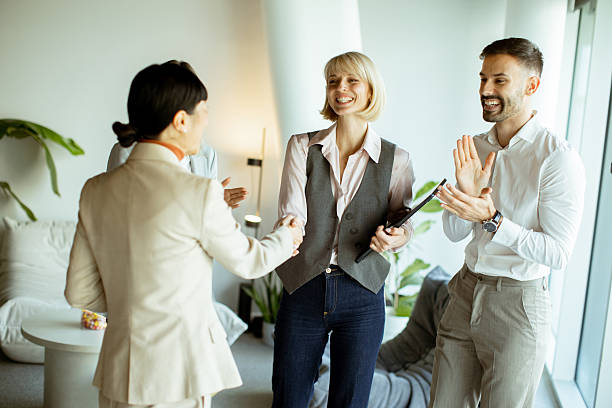 istock Business team members celebrating success in a modern office space 2250950693
