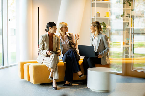 istock Business professionals discuss ideas in a modern office lounge setting 2250950707