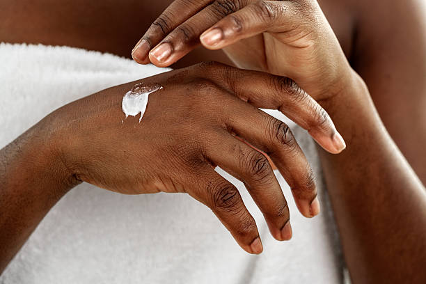 istock Applying moisturizer on hands after a relaxing spa treatment at home during a Sunday afternoon 2250953407