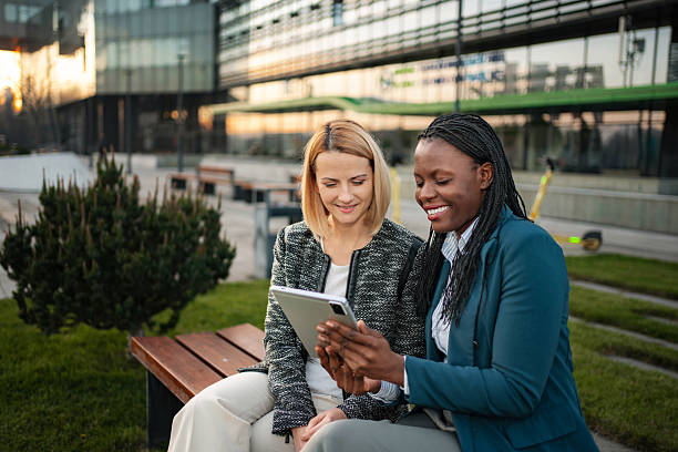 istock Diverse businesswomen collaborating outdoors with digital tablet 2250954237