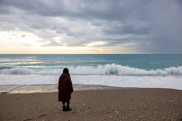 istock A woman alone on the beach 2250955737