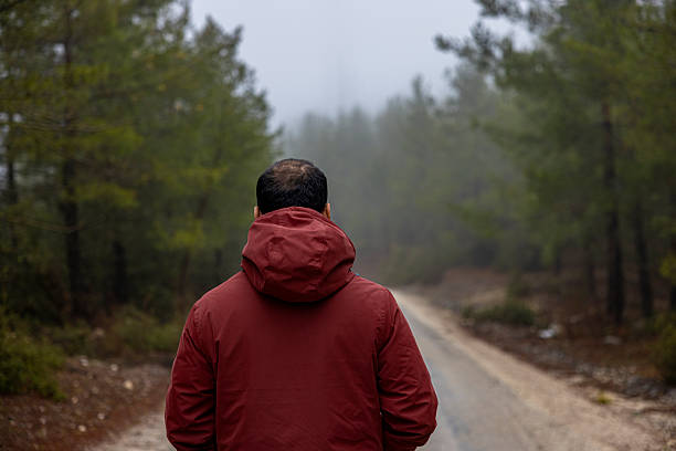 istock A lonely man in a foggy forest 2250956636
