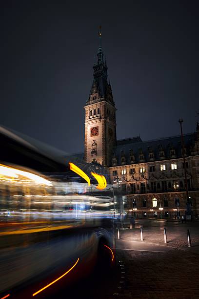 Back view of municipal public transport electric bus driving on paved road Elbe metal bridge in Hamburg old city center hafencity Germany. People commute E-bus traffic transport in Europe town.