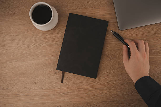 istock A clean and inviting workspace features a laptop, a coffee cup, and a notebook, creating an ideal environment for studying at home. The warm wood surface enhances focus and comfort 2250958722