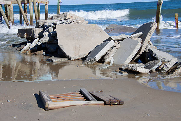 slabs of concrete and destruction lay on the beach in testomony to the power of the Ocean in a storm along the Outer Banks in Buxton, North Carolina