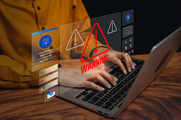 istock Warning alert concept, hands typing laptop with digital caution icons, operational risk awareness, safety monitoring, incident prevention workflow, governance control. 2250958971