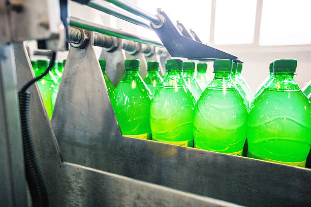 istock Bottles filled with green liquid move through a production line at a beverage manufacturing facility in the afternoon 2250959852