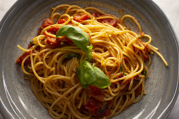 Summer garden inspired spaghetti coated with delicious tomato sauce