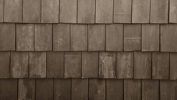 istock Old rustic wood shingles texture background. Brown weathered cedar shake wall siding. Grunge timber roof surface pattern with rough vertical grain details for architectural design. 2250963809