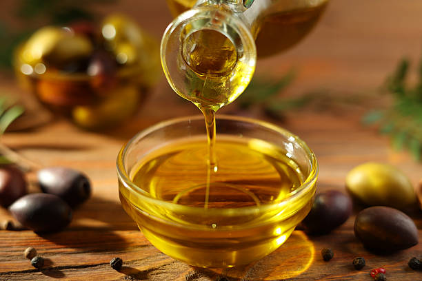 istock A premium olive oil with olives and fresh leaves, 2250964310