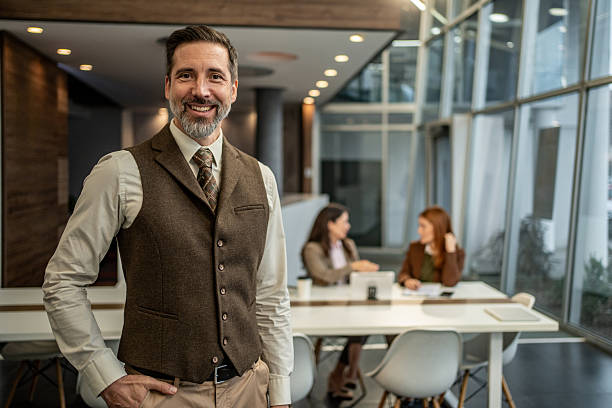istock Confident businessman standing in modern office looking at camera 2250965627