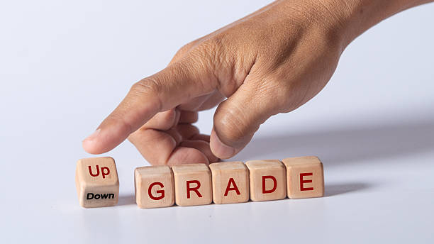 Upgrade or Downgrade words quote in wood dice on white background