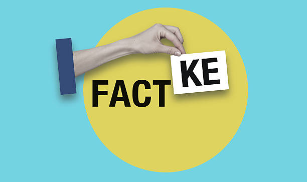 istock A hand holding a fake card with the word fact on it 2250965698