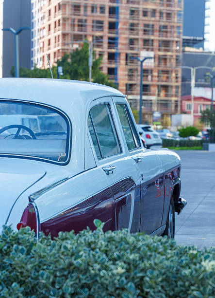 Vintage Car Parked Near Construction Site in Modern Urban Setting. High quality photo