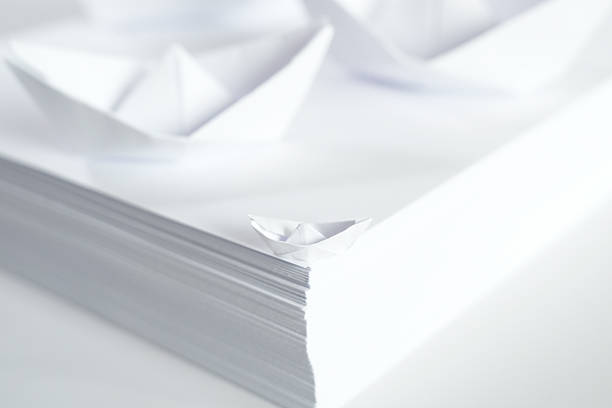 istock Stack of White Paper with Paper Boats 2250967070