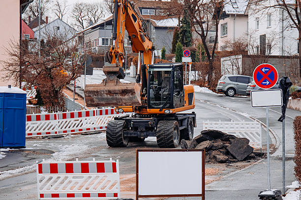 istock Excavator Working at Winter Road Demolition Site 2250968465